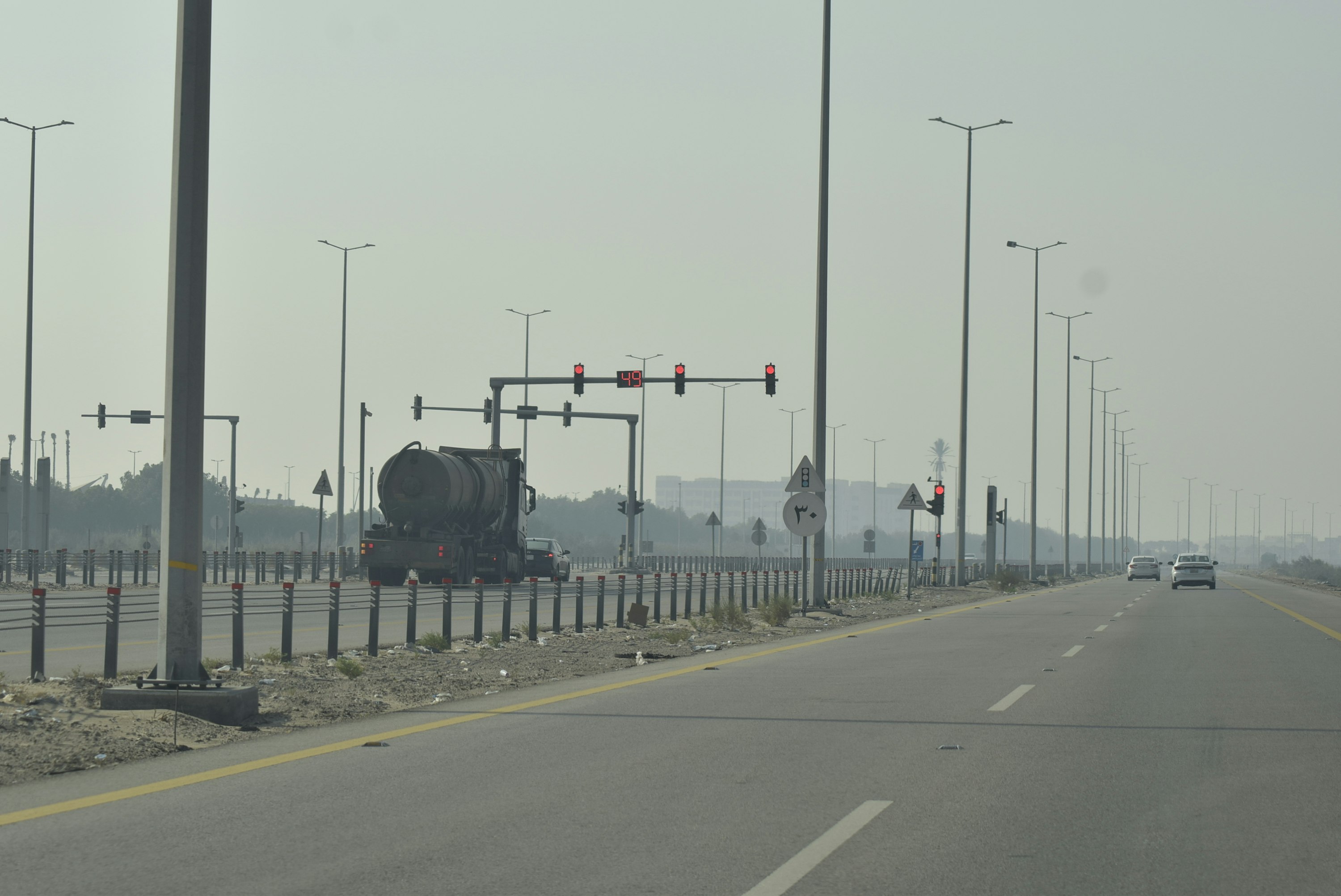 Truck traveling on a highway with traffic lights
